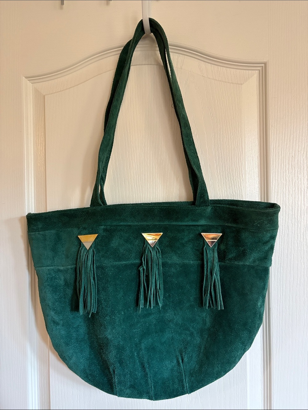 Vintage saddle river suede bag in deep forest green with tassels and gold detail